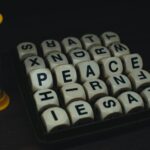 Lettered dice game with visible letters and a small timer on a dark surface.