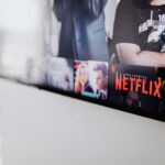 Selective focus of a Netflix screen on a smart TV in an indoor setting.